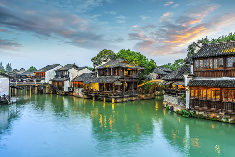 Ancient canal water town with stone bridges and boats