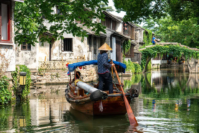 Ancient canal water town with stone bridges and boats